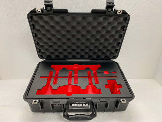 Red and black custom foam insert designed with detailed cutouts to securely hold tools and equipment inside a hard case