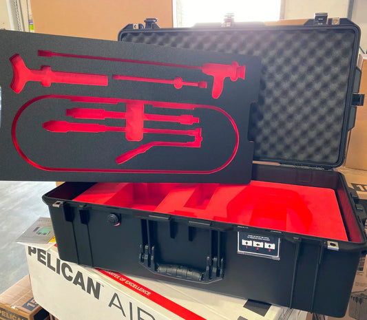 Pelican case with custom-cut foam insert featuring precision-cut cavities for tools and equipment storage