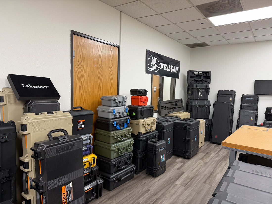 Foamerica Gardena showroom with stacked Protector and Vault cases under a black Pelican banner